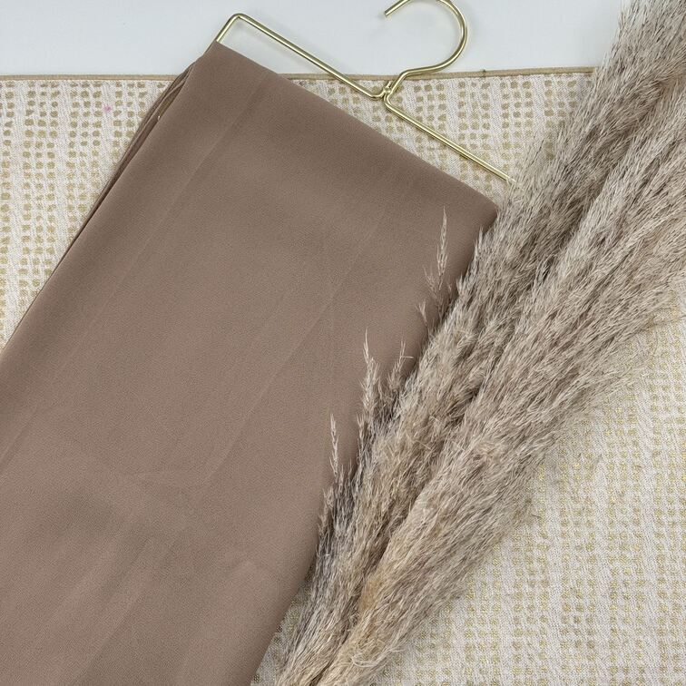 Chiffon Hijab in Tan, lightweight and smooth with a soft drape, offering breathable comfort and versatile styling for everyday wear.